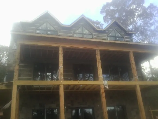 Dormers and porch framing on a large log home under construction in Clarendon Hills