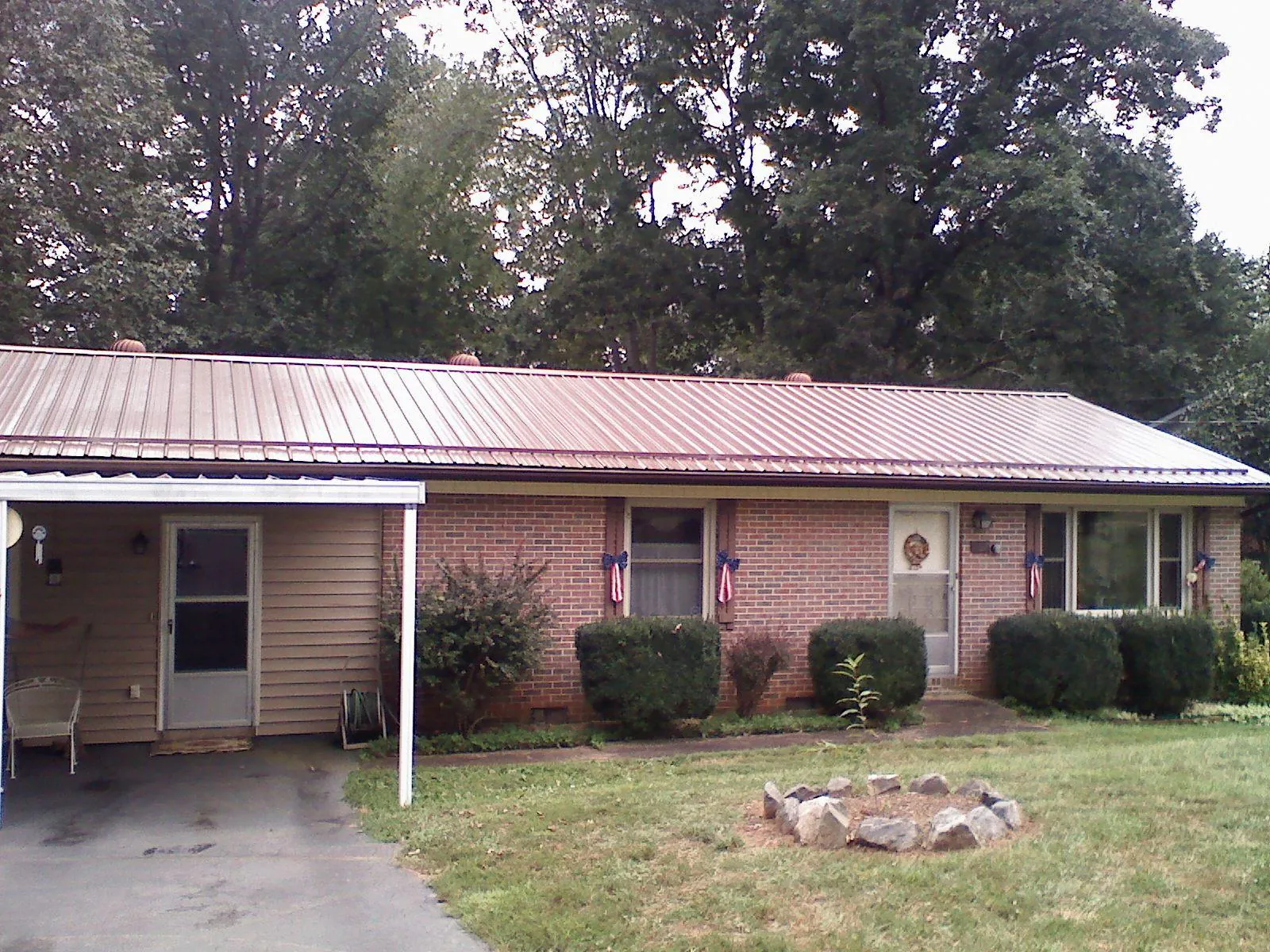 Bronze metal roof and carport on a brick ranch home — Roof Repair work by our crew in Clarendon Hills